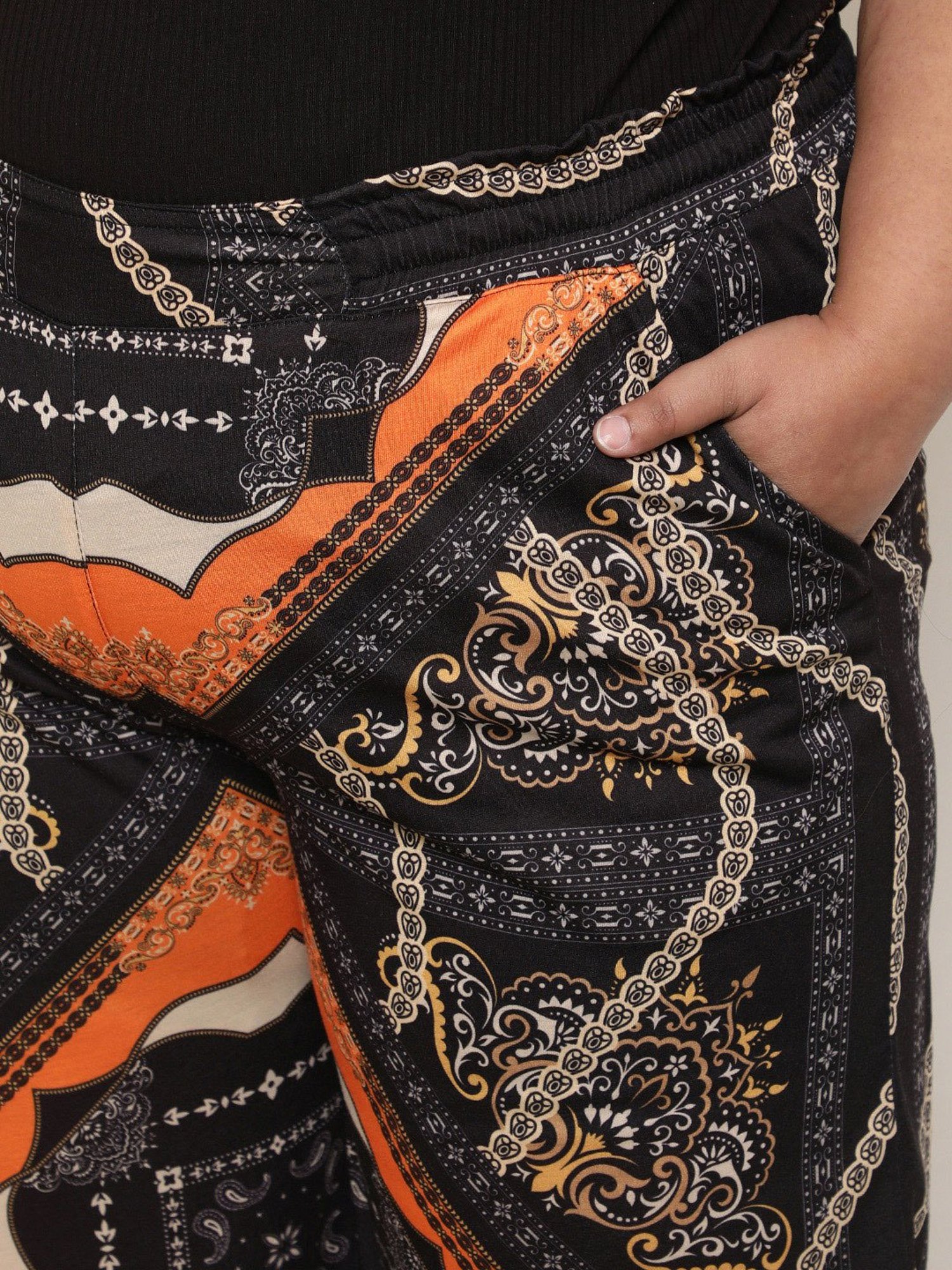 Amydus Black & Orange Printed Flared Fit High Rise Pants