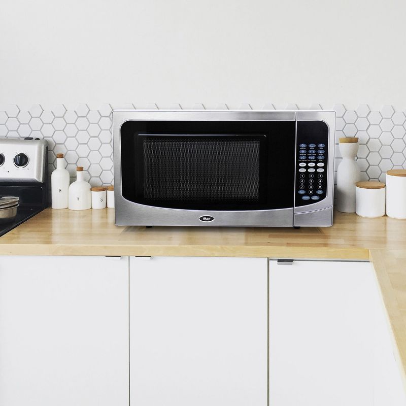 Oster 1.6 Cubic Ft. 1000 Watt Countertop Microwave Oven in Silver