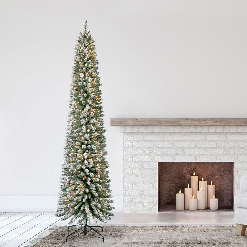 Home Heritage 9 Foot Lowell Snow Flocked Pencil Pine Prelit Decorative Artificial Christmas Tree with Pinecones, Clear White Lights, and Metal Stand