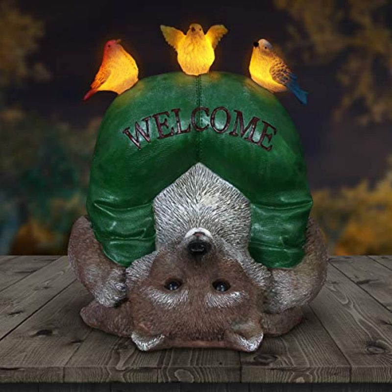exhart solar welcome raccoon & birds garden statue  handpainted statue of an upsidedown raccoon w/welcome sign & birds on top  raccoon decor w/solar led accent lights 8.66l x 6.69w x 10.24h