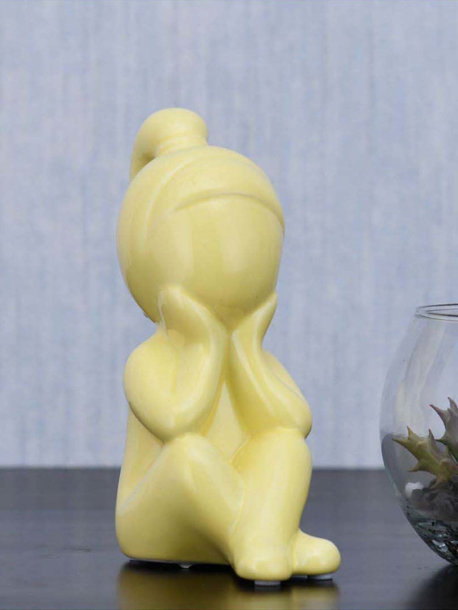 @home Yellow Resin Girl Sitting With Hand On Chin Decorative Showpiece