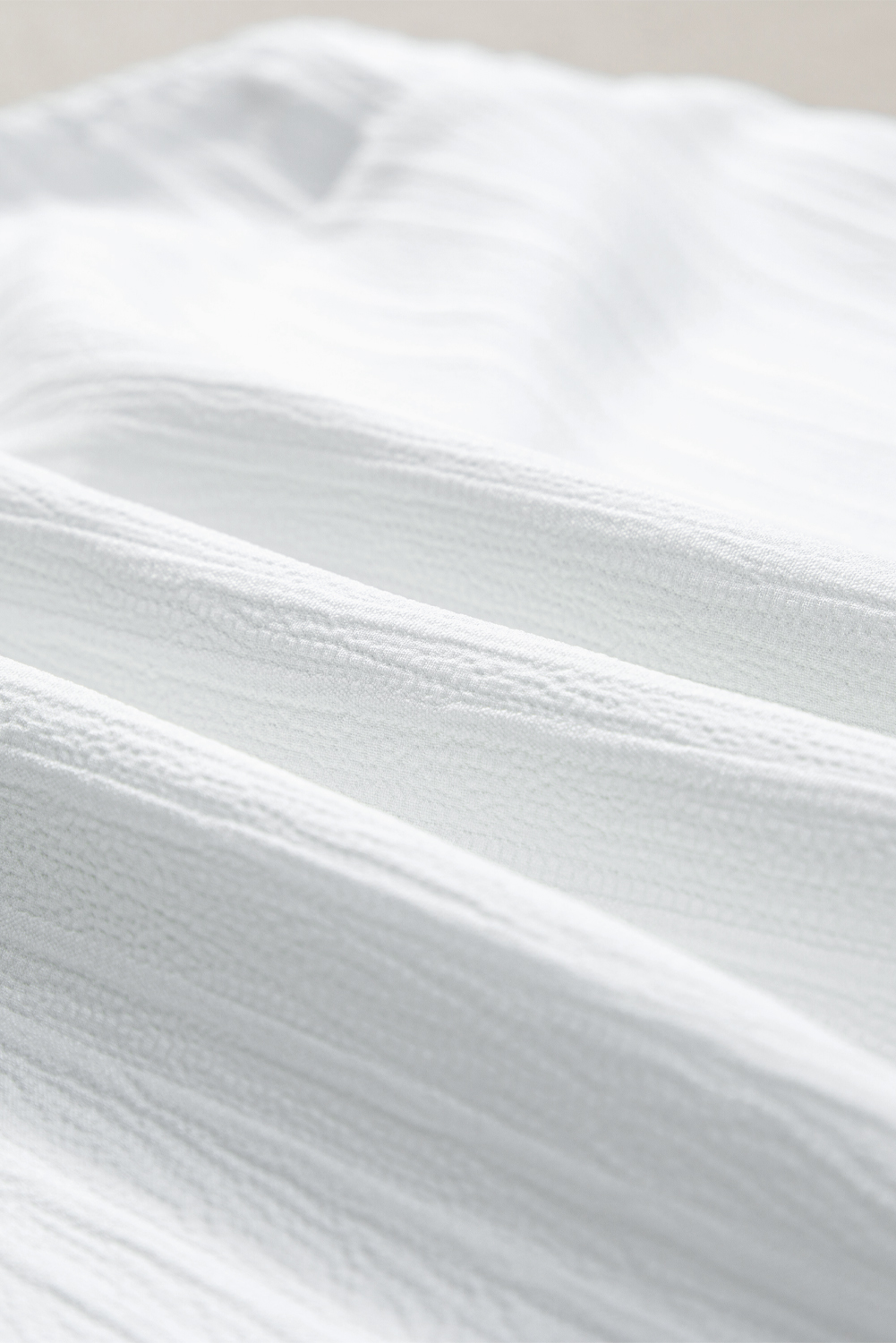 White Solid Color Asymmetrical Knot Textured Sleeveless Shirt