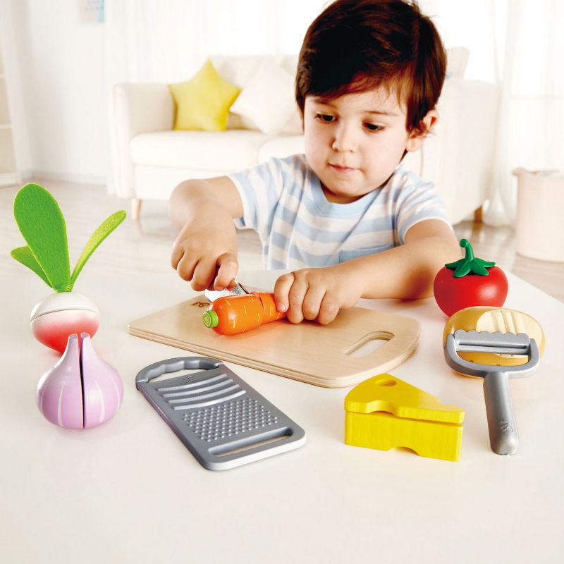 Hape E3154 Cooking Essentials Kids Wooden Pretend Kitchen Play Food Toys and Accessories Set with Vegetables, Cheese, Knife, Peeler, and Grater