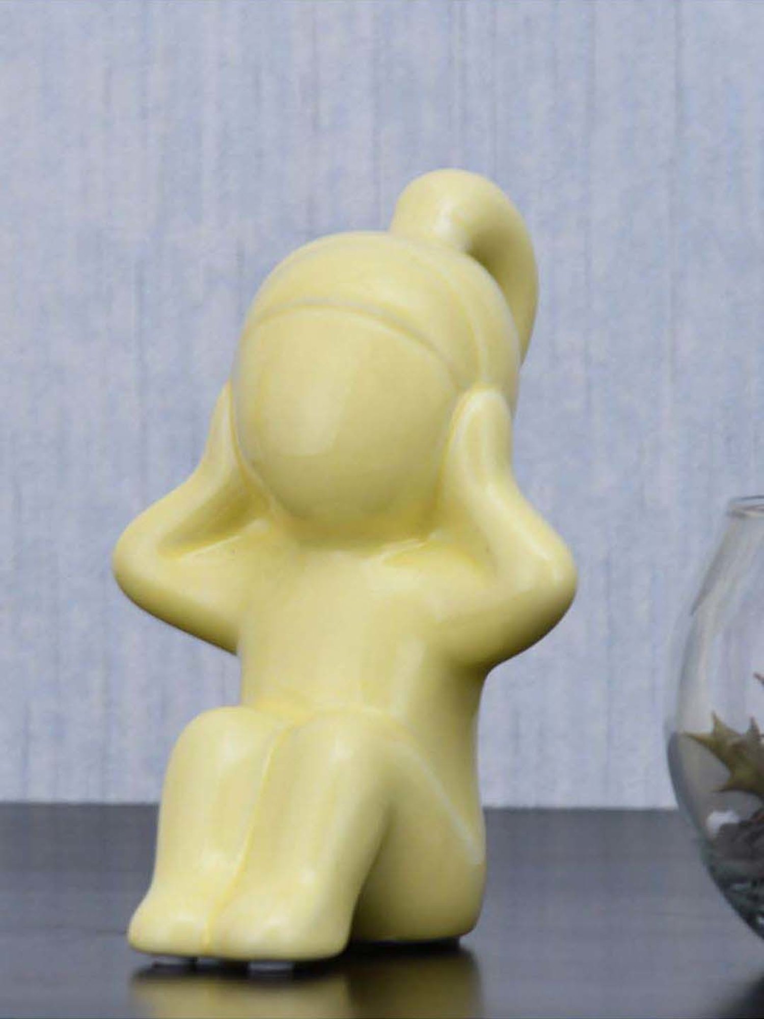 @home Yellow Resin Girl Hear No Evil Decorative Showpiece