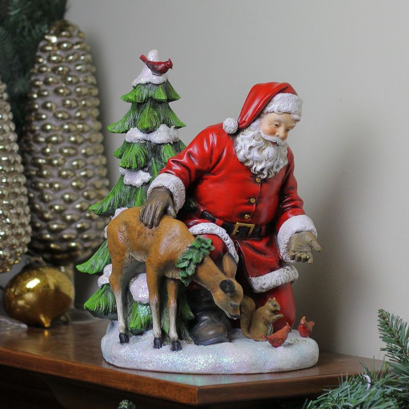 Napco 11.5" Red and White Santa Claus Feeding The Animals Christmas Table Figurine