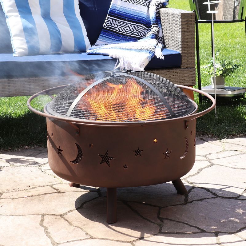 Sunnydaze Outdoor Camping or Backyard Round Cosmic Stars and Moons Fire Pit with Cooking Grill Grate, Spark Screen, and Log Poker - 30"