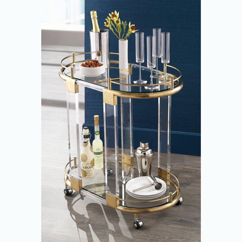 55 Downing Street Adaline 29 1/2" Wide Clear Acrylic and Gold Oval Bar Cart
