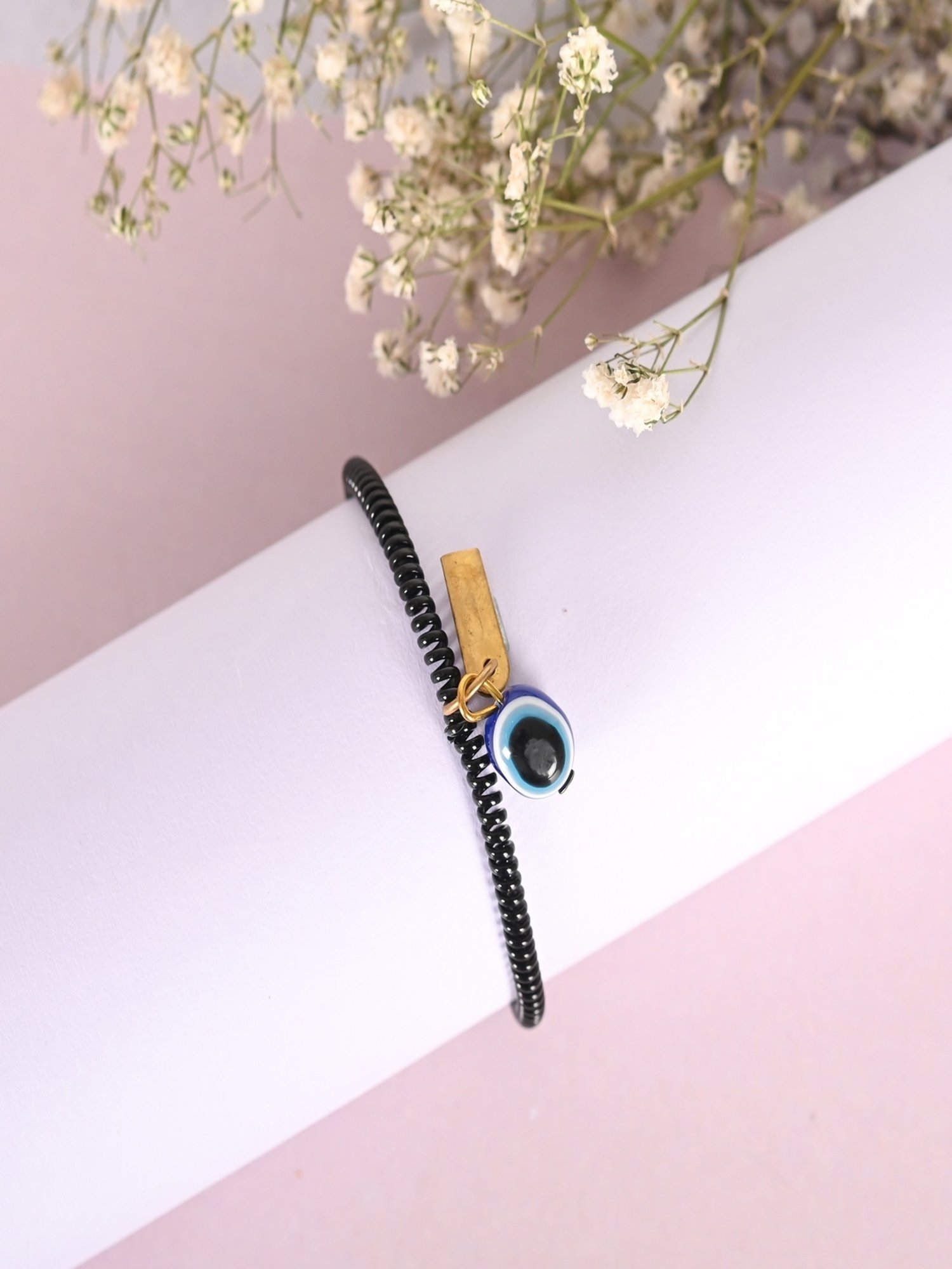 NVR Black Evil Eye Spring Ring Rakhi with Roli Chawal