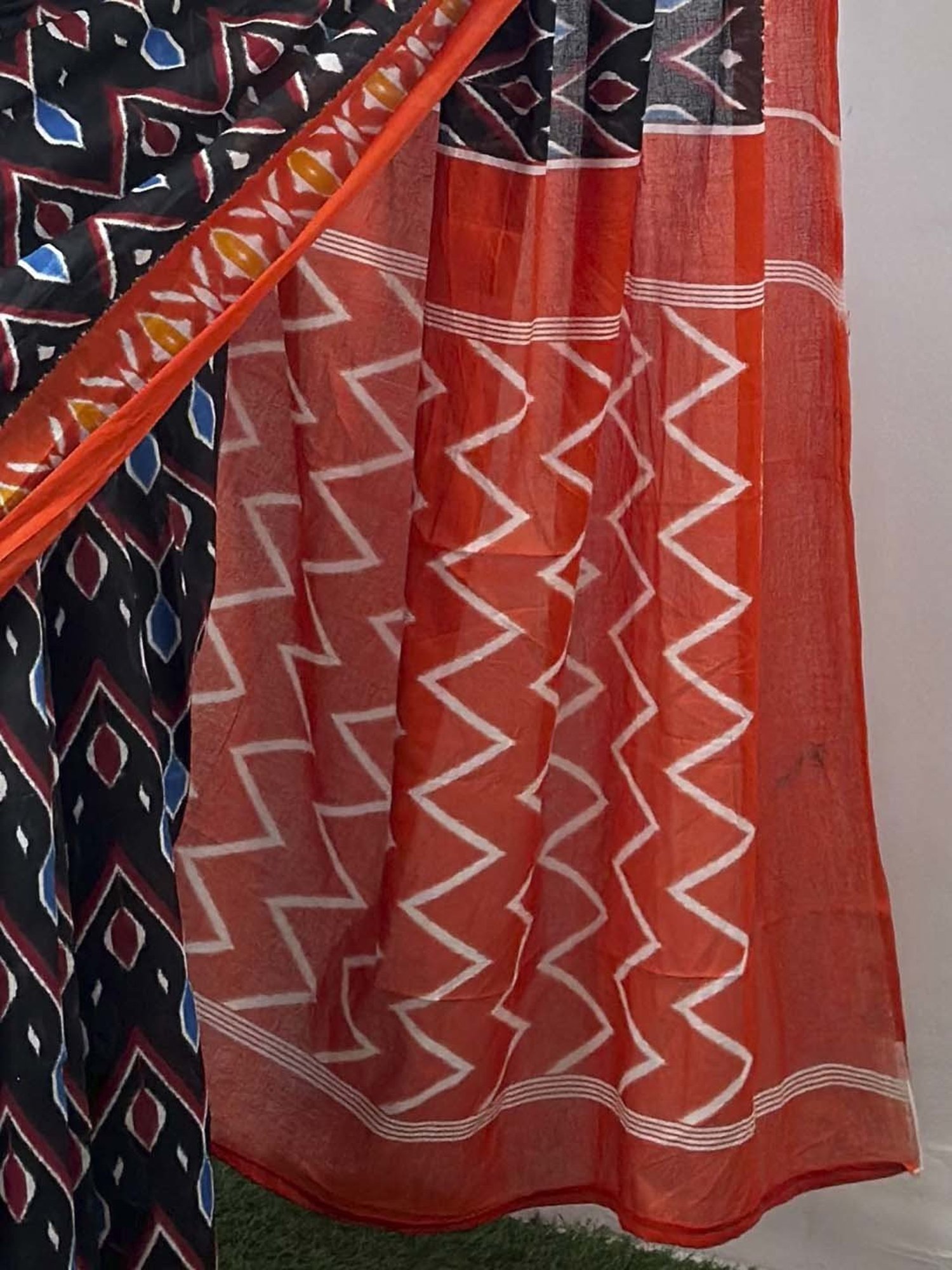 Saree Mall Black & Orange Cotton Printed Saree With Unstitched Blouse