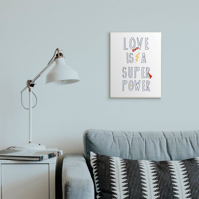13"x19" Love is a Super Power Quote with Superhero Gear Oversized Wall Plaque Art by Daphne Polselli - Stupell Industries