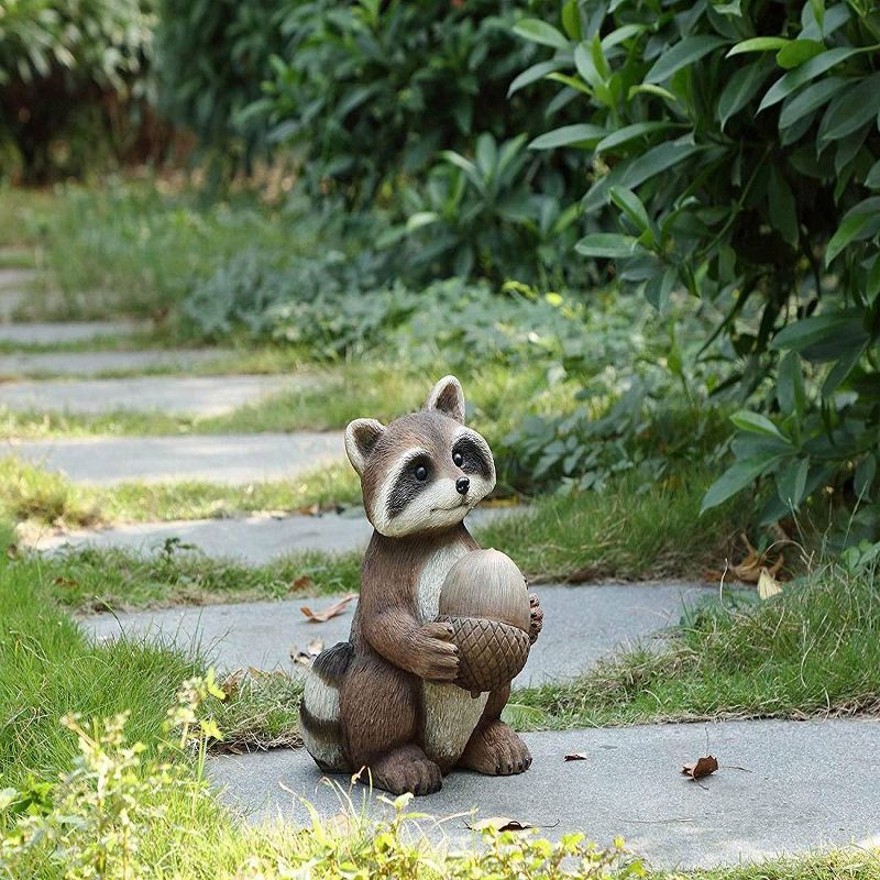 12" Polyresin Raccoon Holding Acorn Outdoor Statue Brown - Hi-Line Gift