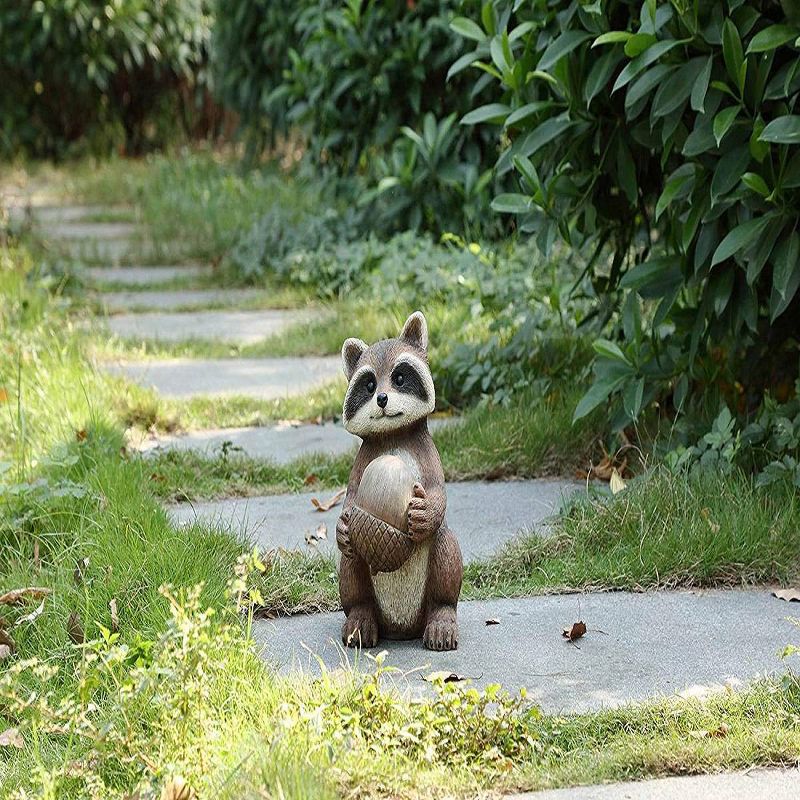 12" Polyresin Raccoon Holding Acorn Outdoor Statue Brown - Hi-Line Gift