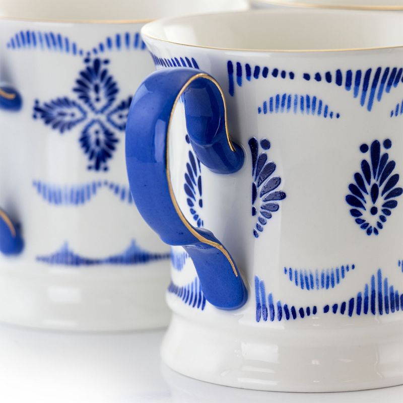 Meritage Navy 12 Piece 13.2 Ounce Fine Ceramic Cup Set in White with 4 Assorted Designs